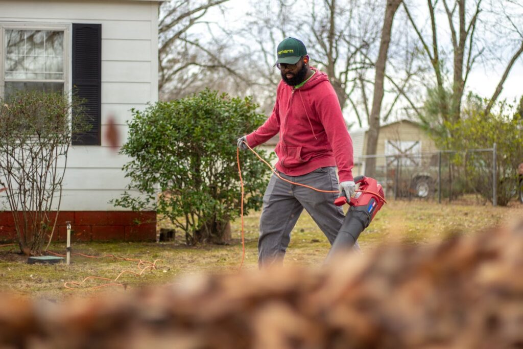 man blowing mulch into place